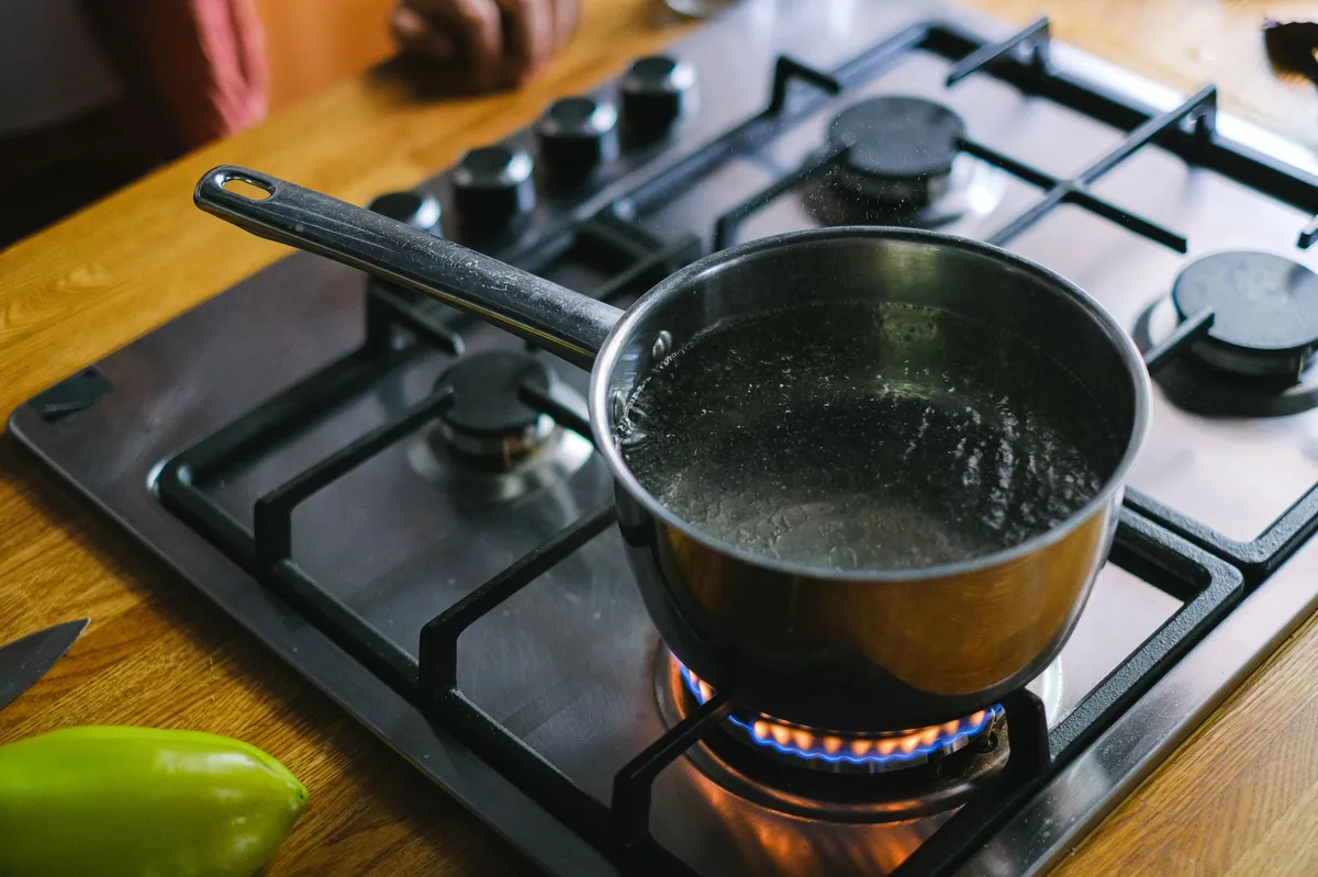 Panela de inox no fogão a gás com água fervente